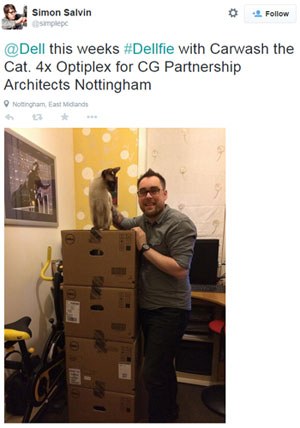Simon Salvin standing next to four Dell Optiplex boxes with a cat on top