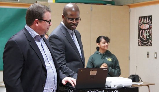 Jon Phillips and Superintendent Antwan Wilson playing a student-created game on Dell Chromebook