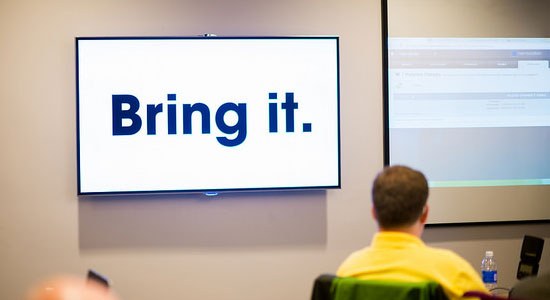 digital signage from Dell spells out the words Bring IT in a conference room