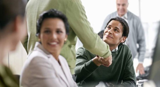 People shake hands in an office meeting room to illustrate Dell Digital Business Services Joins MIT’s Initiative on the Digital Economy