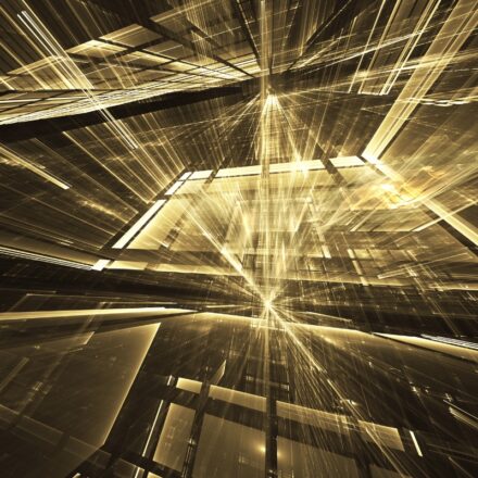 Abstract image of gold colored fractals and rays against a dark background.