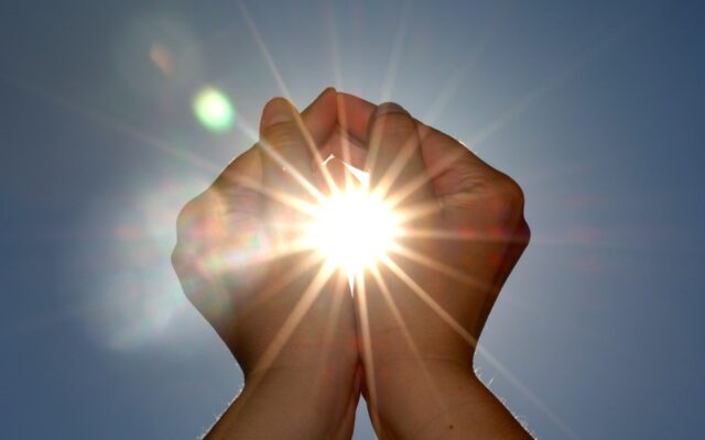 Looking at the sun between two cupped hands.