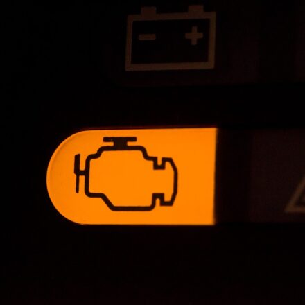 Orange check engine light alert appearing on a car's dashboard.