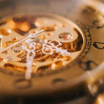 Intricate workings of a gold watch's mechanism, requiring attention to detail and engineering skill.