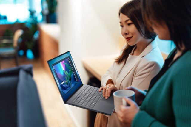 TWo women looking at a Dell Pro Max 14 premium laptop