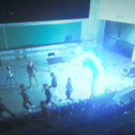 video game screenshot of a bunch of people looking at another person in a bright light